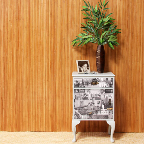 Burnt Honey flexible bamboo wall panelling installed in a room with a cabinet and plant