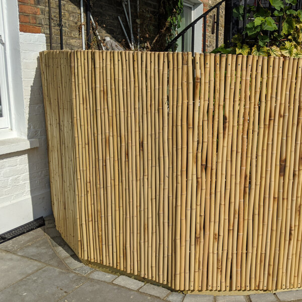 A moso bamboo screen screwed to be secure in a customer's garden