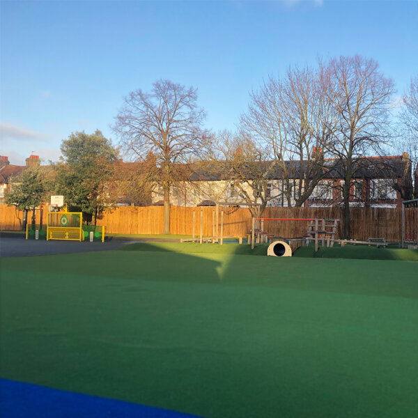 Natural bamboo roll screens installed along the boundary of a school in London