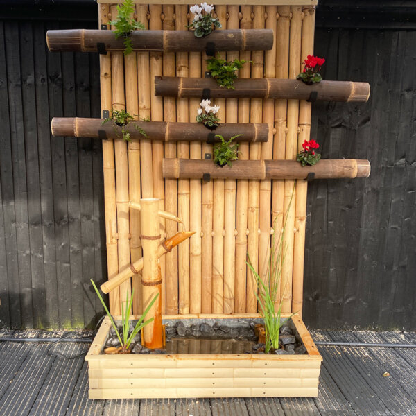 A tali round pole fence panel customised with java black bamboo planters and water feature