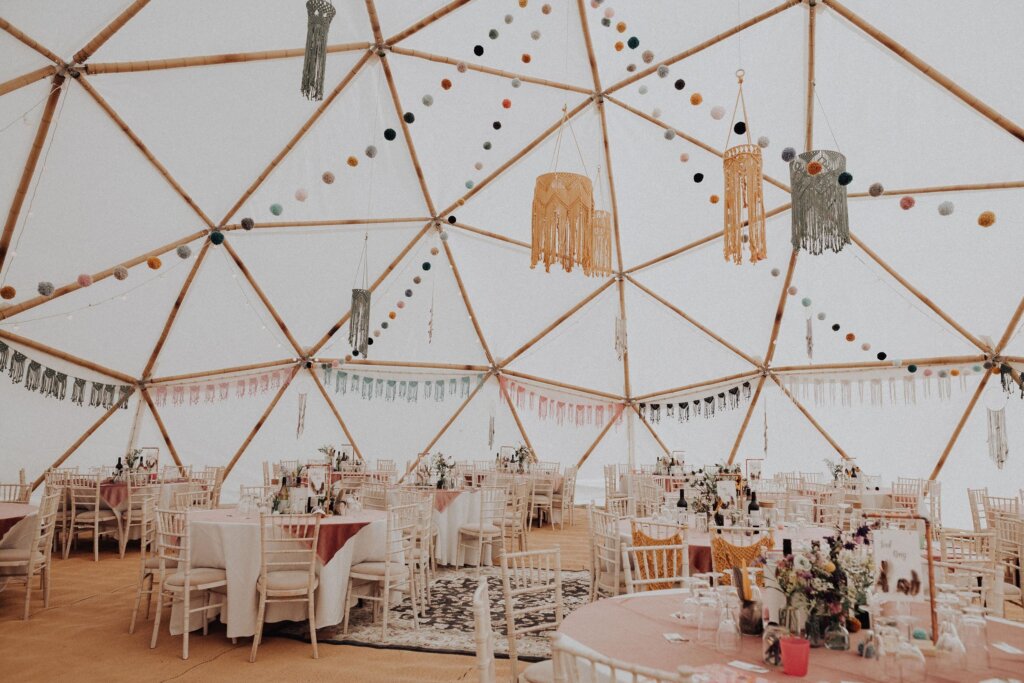 The interior of a giant bamboo geodesic dome made by Atlas Domes, set out for a wedding