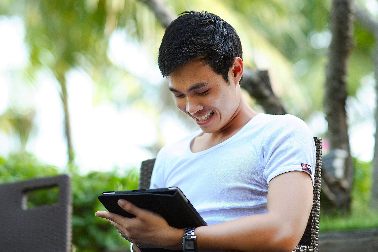 A smiling man orders bamboo on his tablet