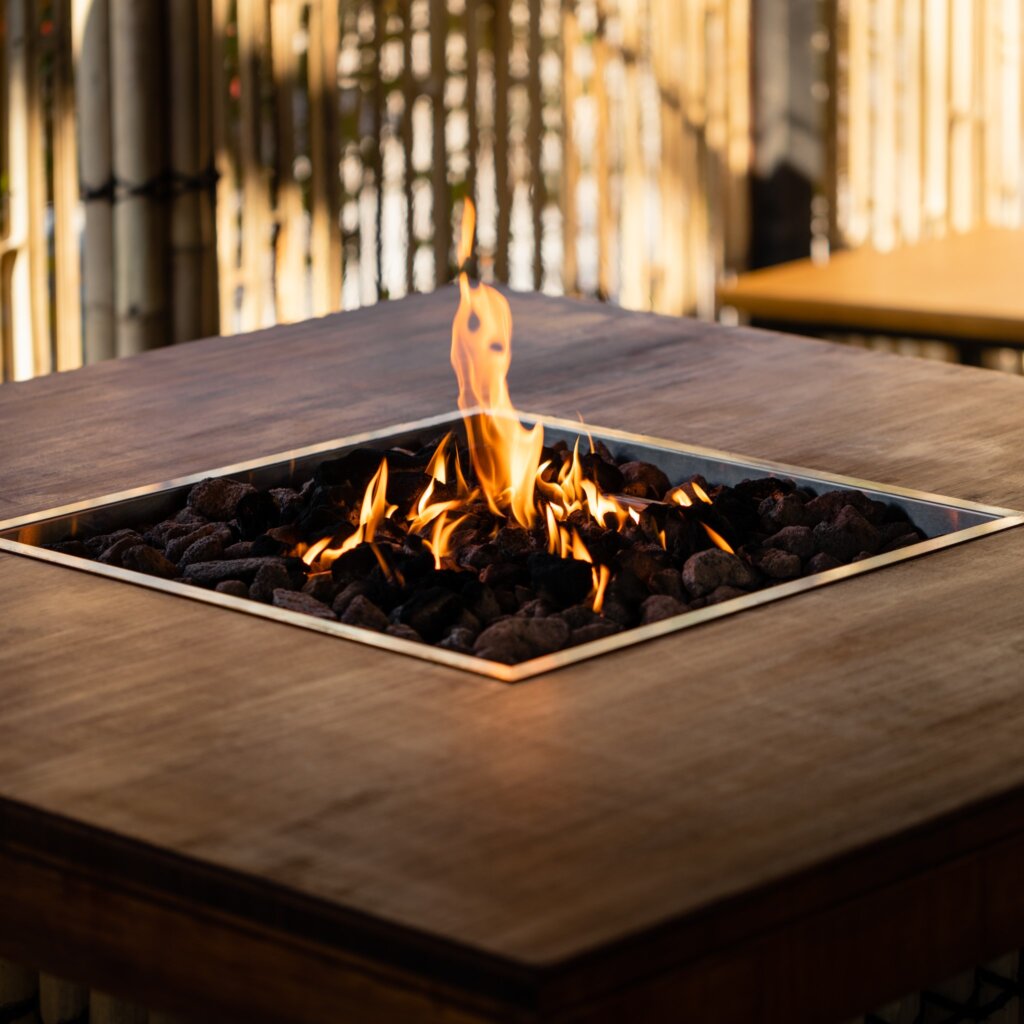 The garden fire pit at Zen Durham uses stained bamboo plyboard around the pit